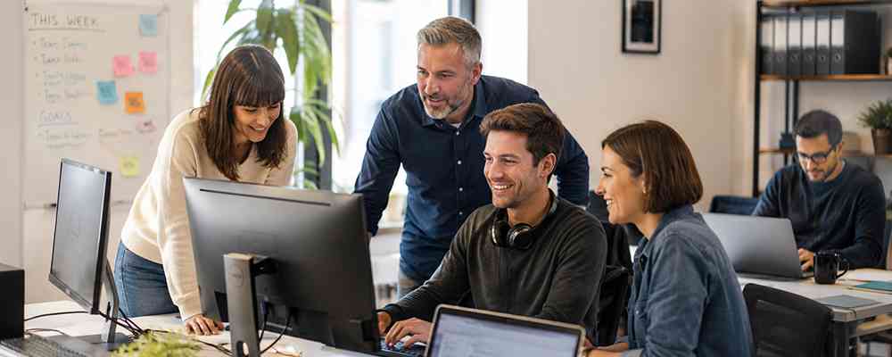 Team experiencing the benefits of upgrading business IT with fast modern computers and collaboration tools